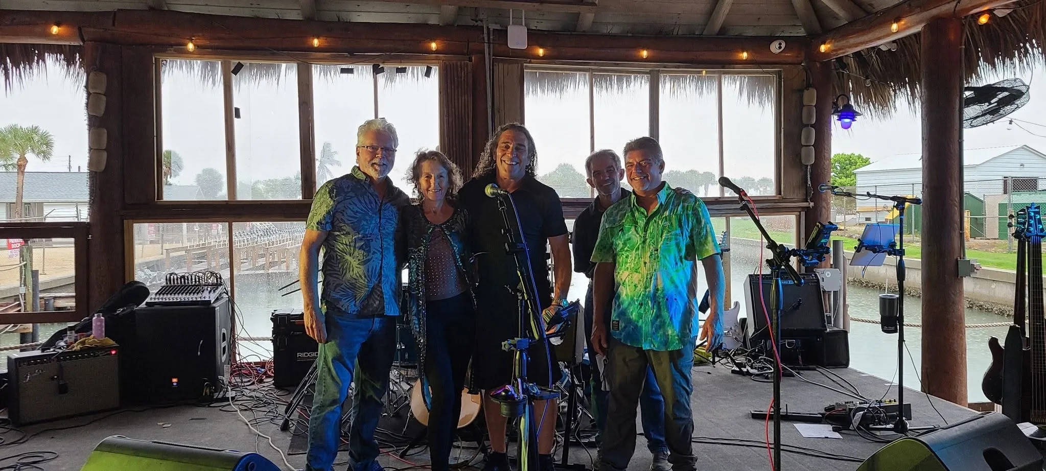 The Rita B Band lineup together on a tiki-bar stage in Southwest Florida