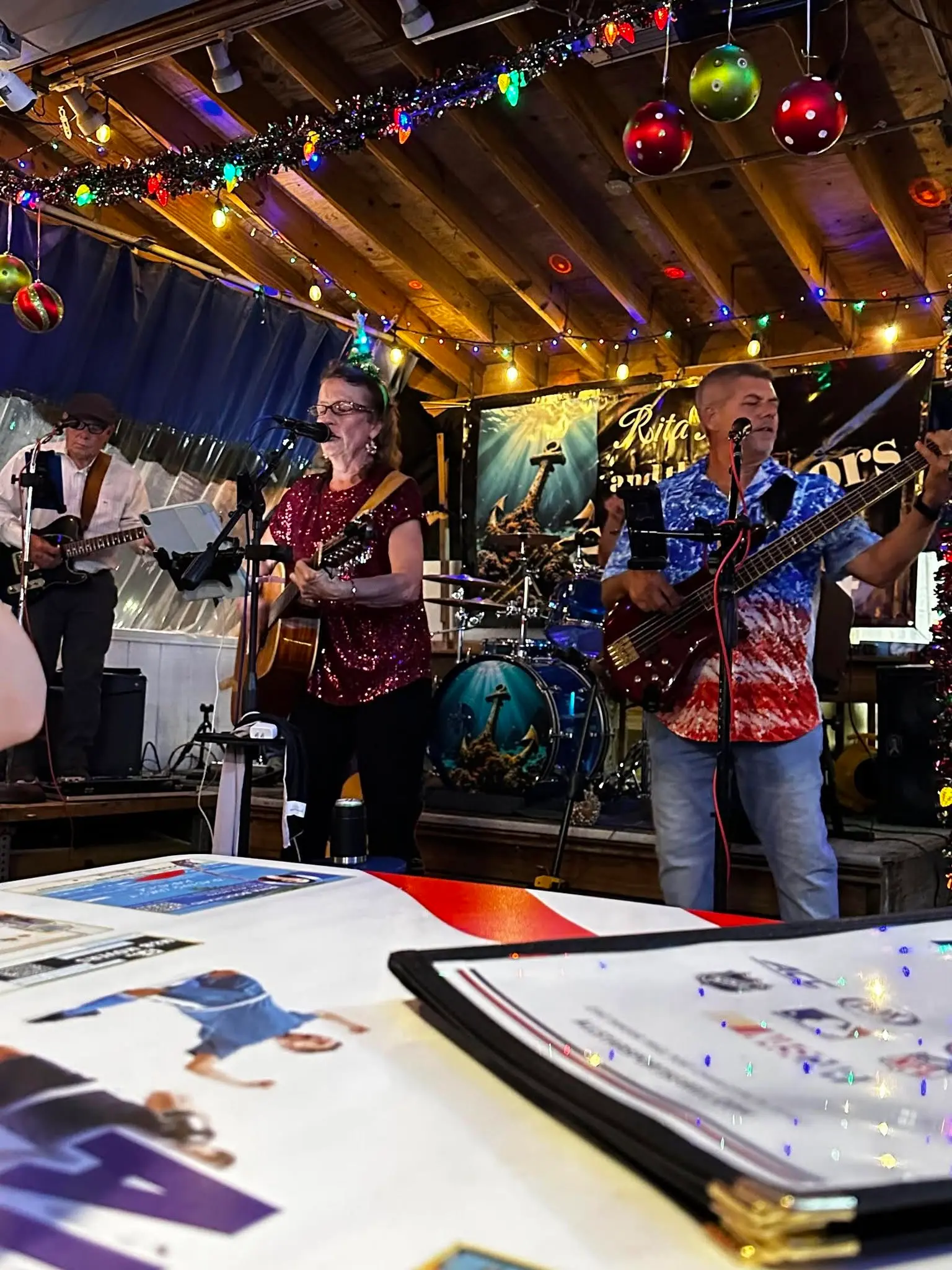 The Rita B Band playing under Christmas lights