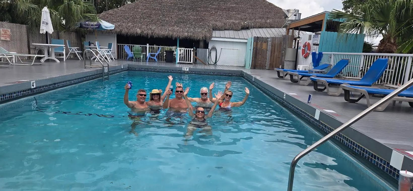 Fans waving from a pool during an outdoor show