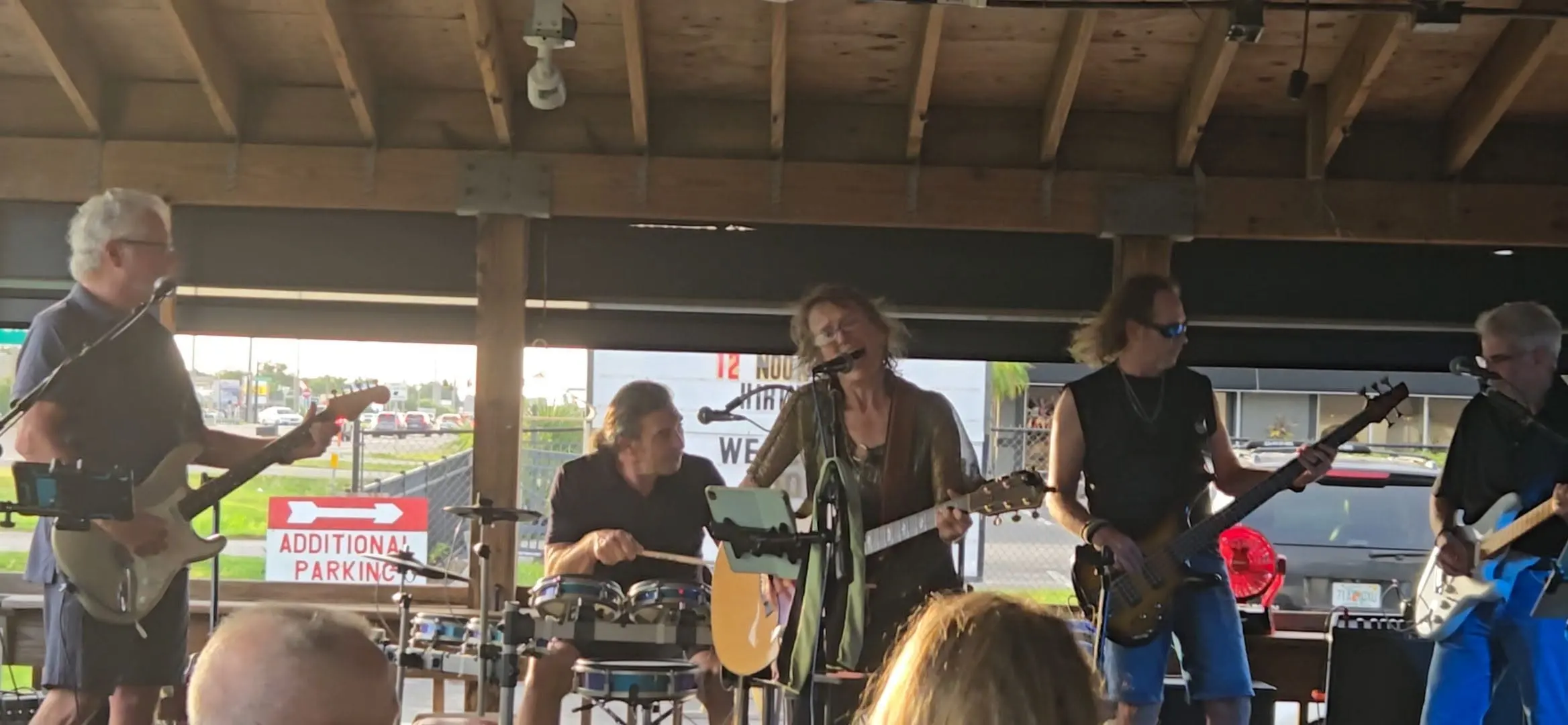 The Rita B Band mid-song on a tiki stage in Southwest Florida